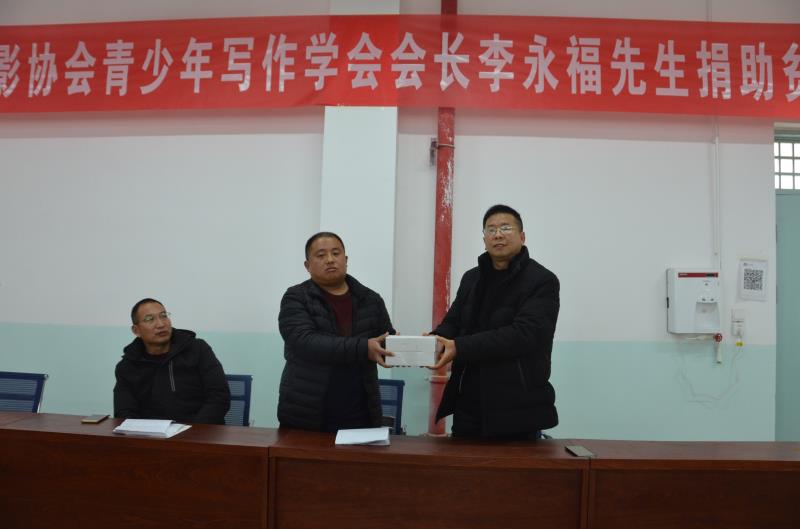 商丘市微電影協(xié)會青少年寫作學會會長李永福為貧困學生捐贈學習卡